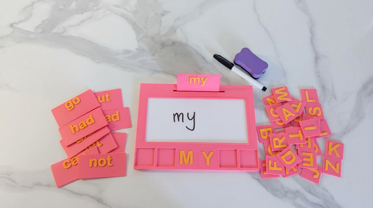 Pink Entirely Kids Sight Word Board with sight word cards, alphabet letter tiles, whiteboard marker and eraser